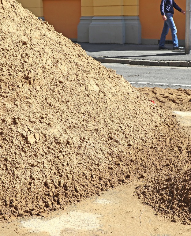 Construction delivery truck at a construction site, highlighting ALC Logistics transport services.